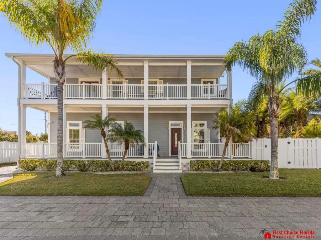 Charming two-story home with spacious balconies and palm trees
