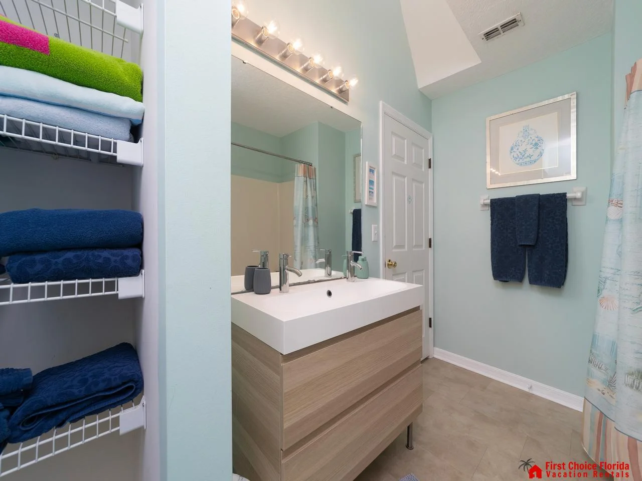 Bright, modern bathroom with ample storage and fresh linens