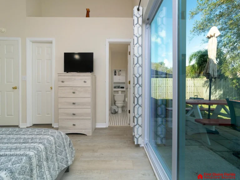 Bright bedroom with garden views and private patio access