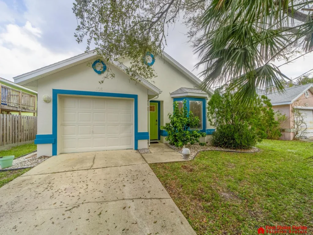 Charming beach home with a large front yard and fence back yard.