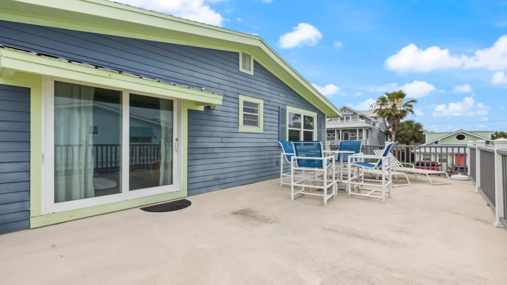 Primary bedroom balcony with outdoor seating.
