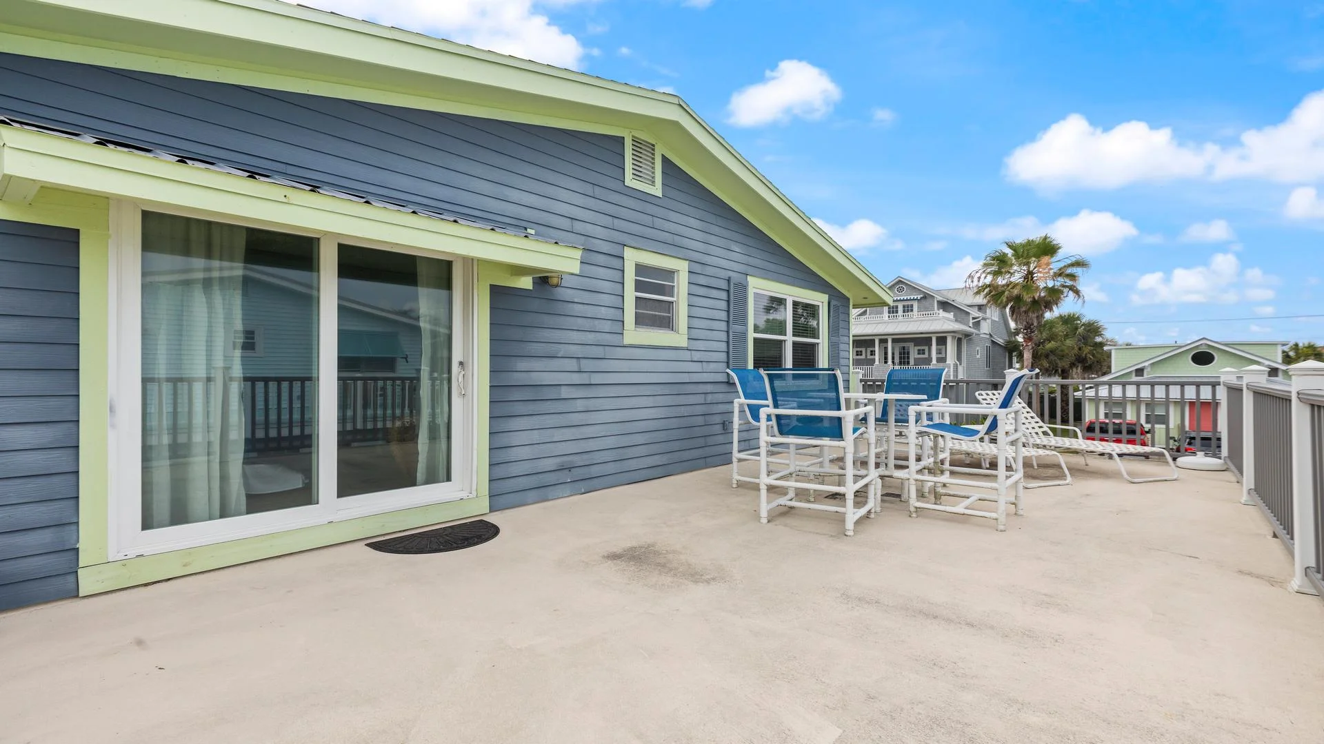 Primary bedroom balcony with outdoor seating.