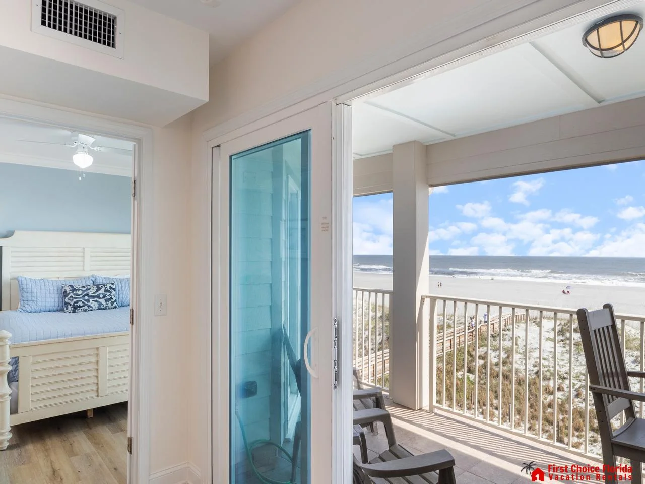 Sunlit balcony with ocean views and cozy seating