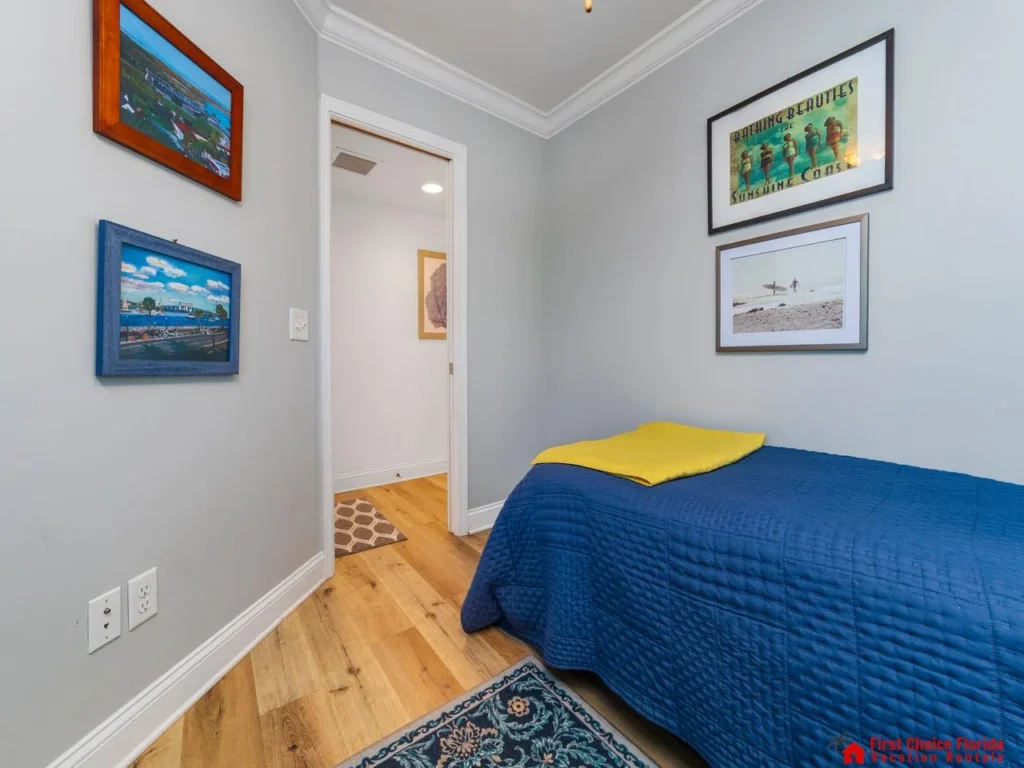 Cozy bedroom retreat with vibrant local artwork and hardwood floors