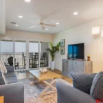 Bright and airy living room with cozy seating and balcony access