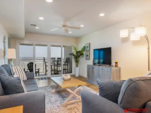 Bright and airy living room with cozy seating and balcony access