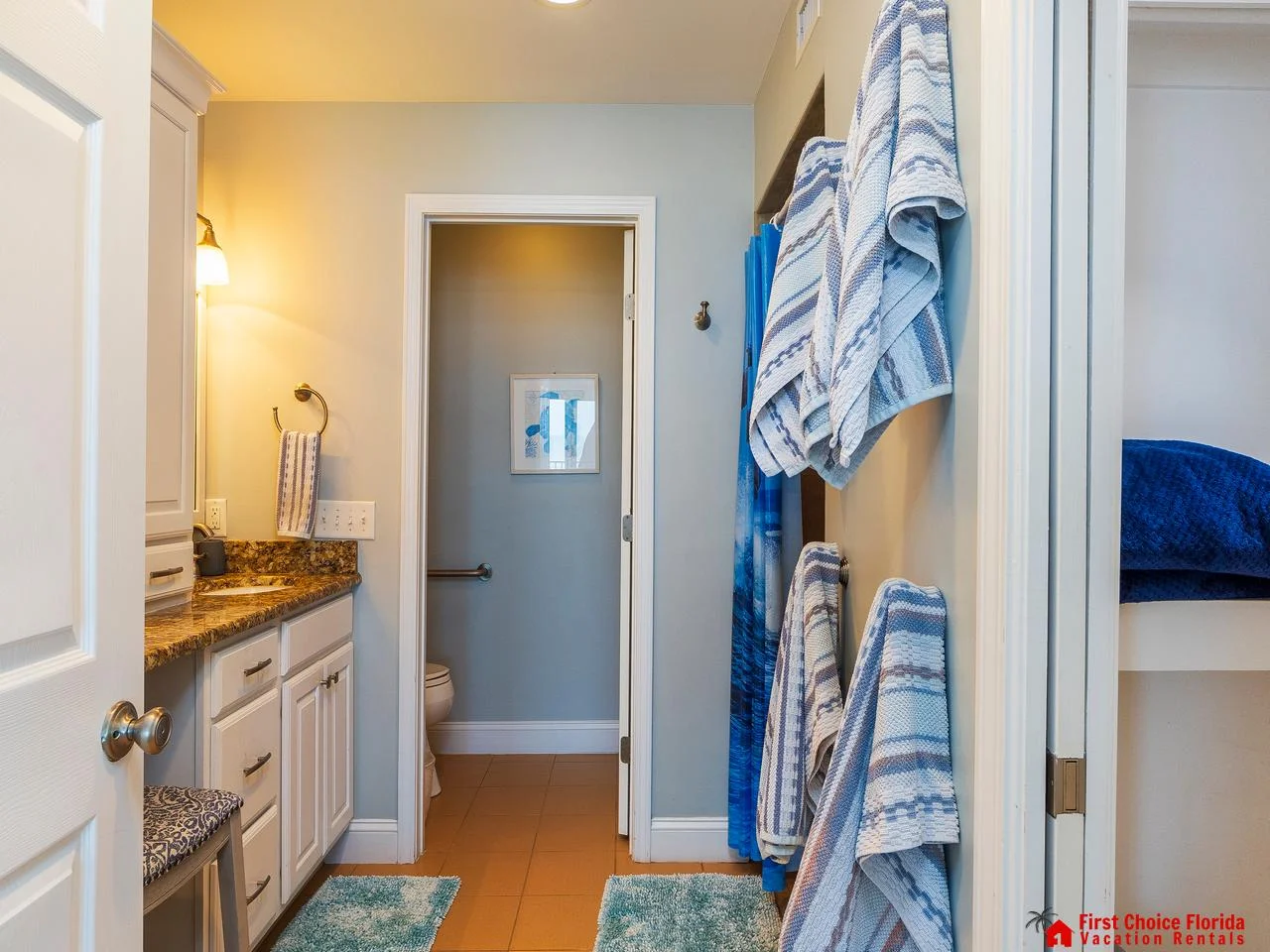 Bright, airy primary bathroom with cozy towel accents and natural light