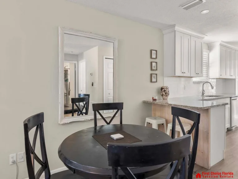 Cozy dining nook with elegant black accents and bright kitchen
