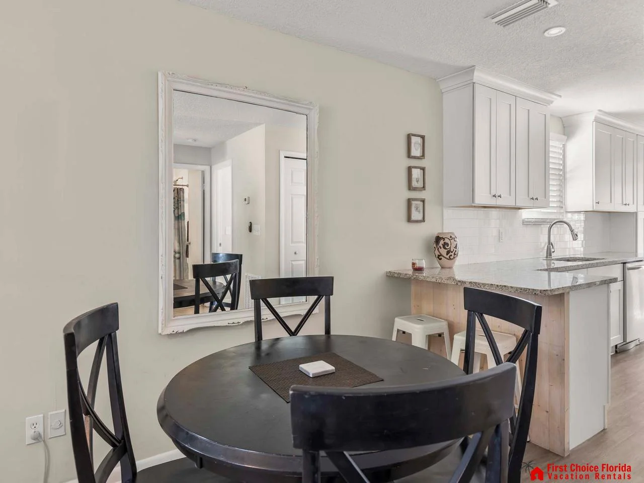 Cozy dining nook with elegant black accents and bright kitchen