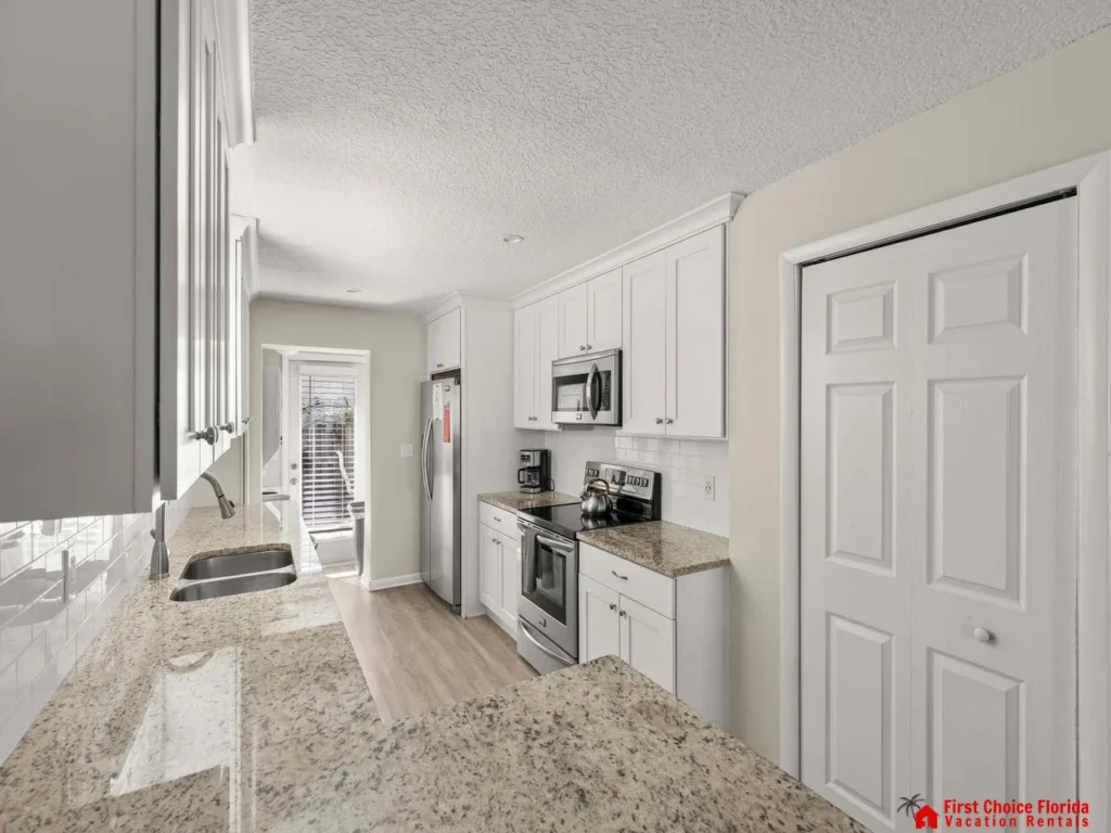Bright, modern kitchen with granite countertops and stainless steel appliances
