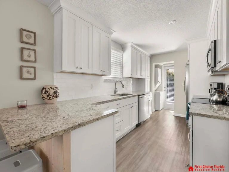 Bright, modern kitchen with granite countertops and stainless steel appliances