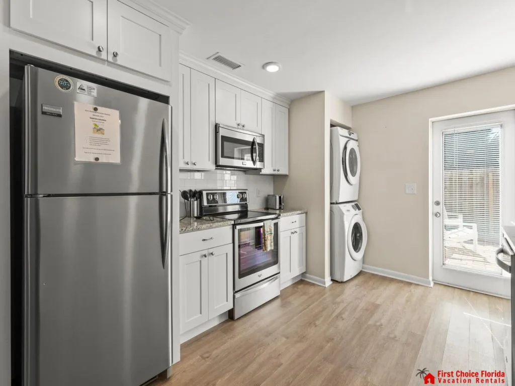Bright kitchen with modern appliances and laundry area