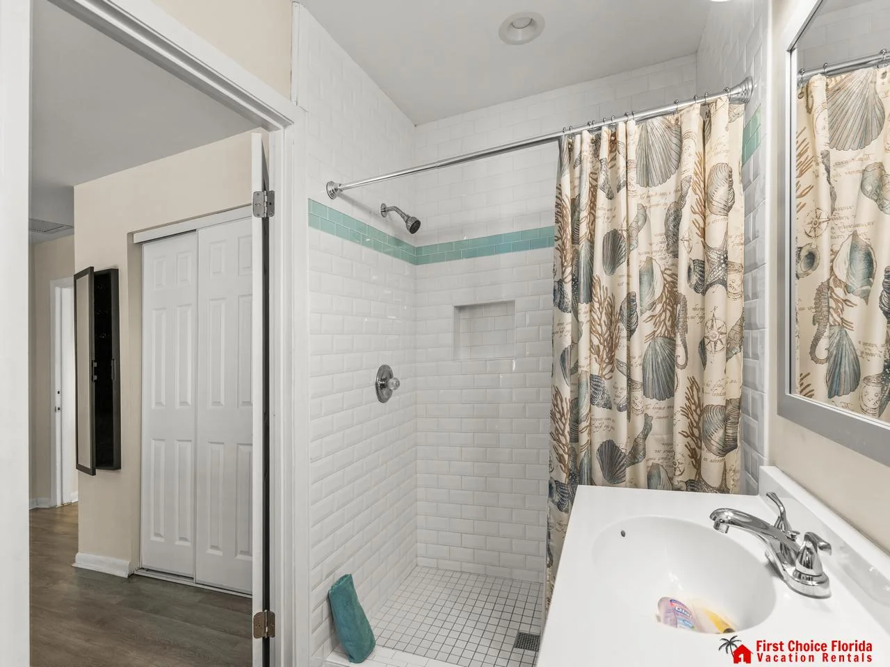 Bright, airy bathroom with classic subway tile and cozy shower curtain