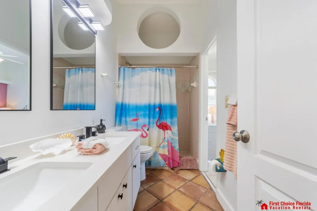 Bright, airy bathroom with colorful shower curtain and ample counter space!