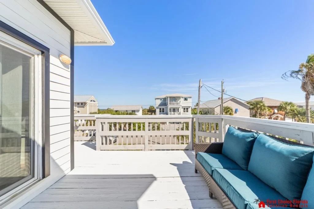 Sunny balcony retreat with cozy seating and ocean views!