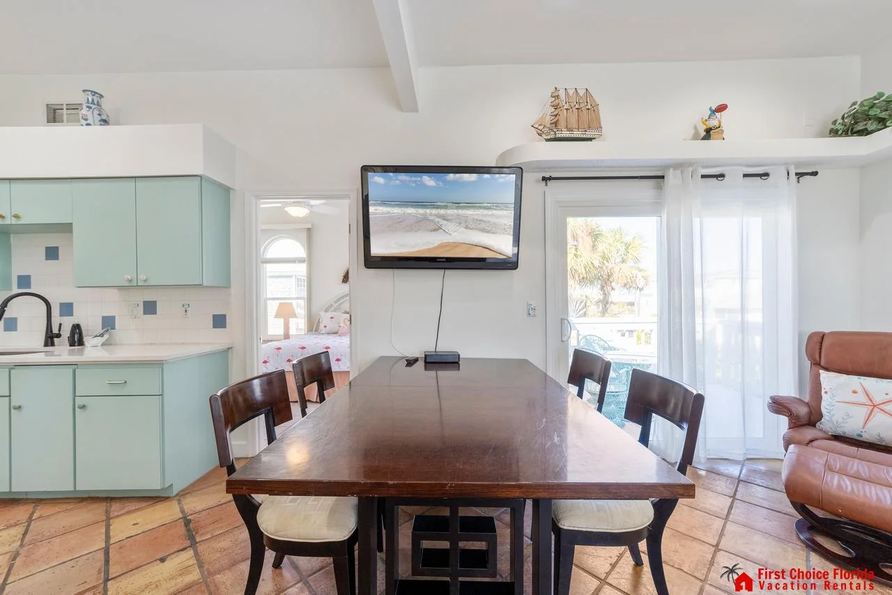 Bright dining area with ocean views and cozy seating!