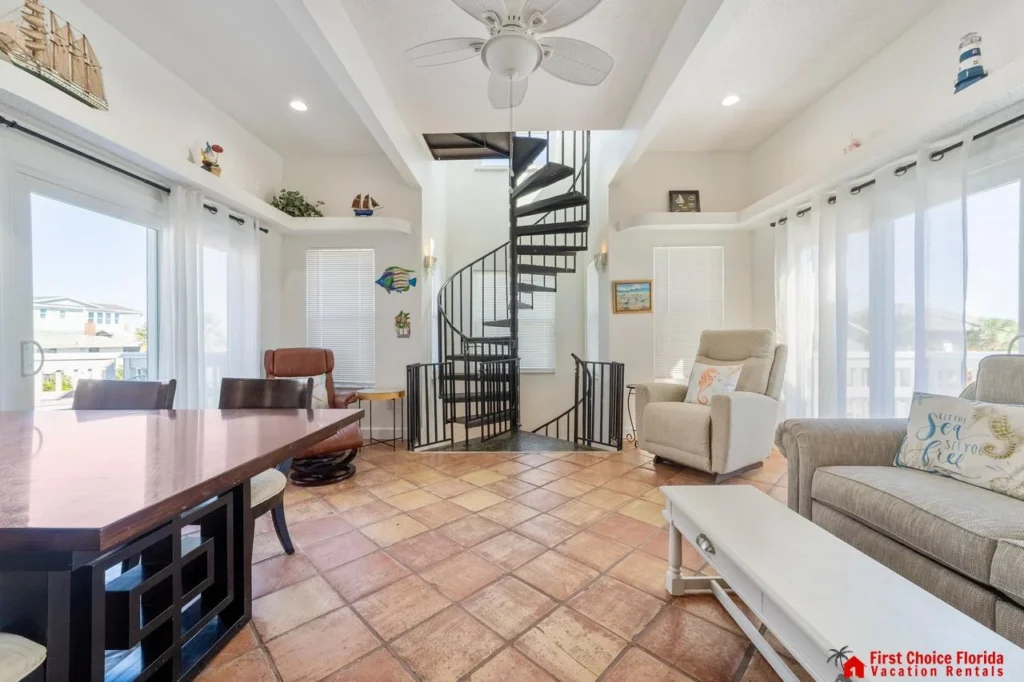 Bright, airy living room with spiral staircase to third floor bedroom!