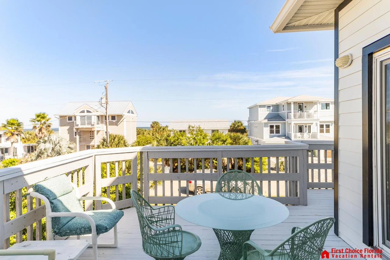 Sunlit balcony with cozy seating and ocean views!