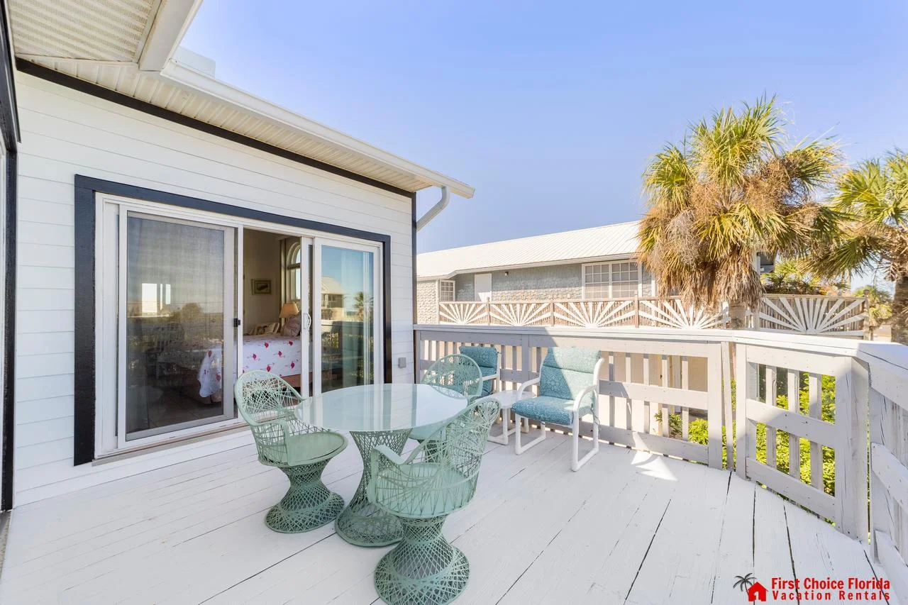 Sunny balcony retreat with cozy seating and ocean breeze views!