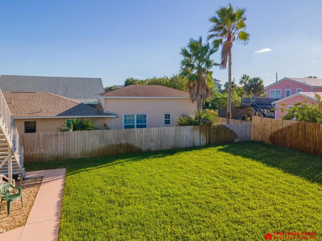 Spacious fenced backyard with lush green lawn for play and relaxation!