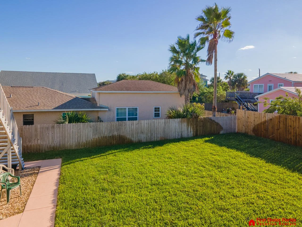 Spacious fenced backyard with lush green lawn for play and relaxation!