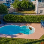 Private backyard pool with cozy seating for relaxation!
