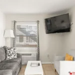 Cozy living room with plush seating and wall-mounted TV