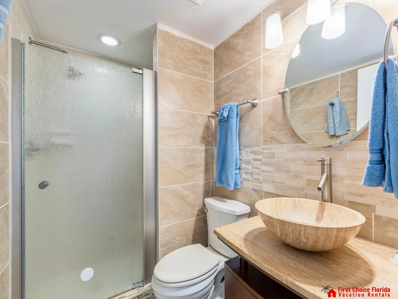 Primary bathroom retreat with stylish vessel sink and glass shower