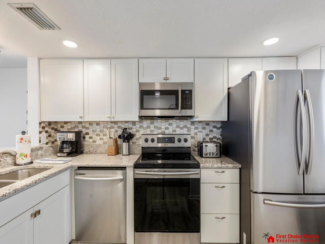 Modern kitchen with sleek appliances and stylish backsplash