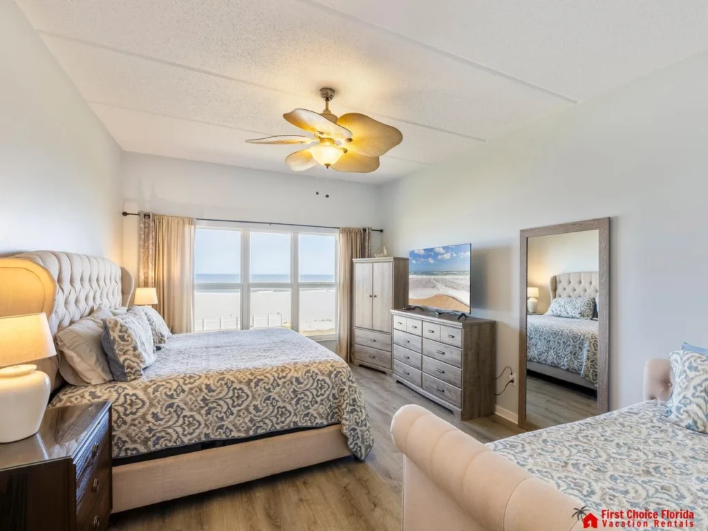 Sunlit primary bedroom with ocean views and cozy comfort