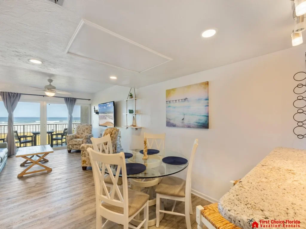 Bright and airy dining area with ocean views and cozy seating