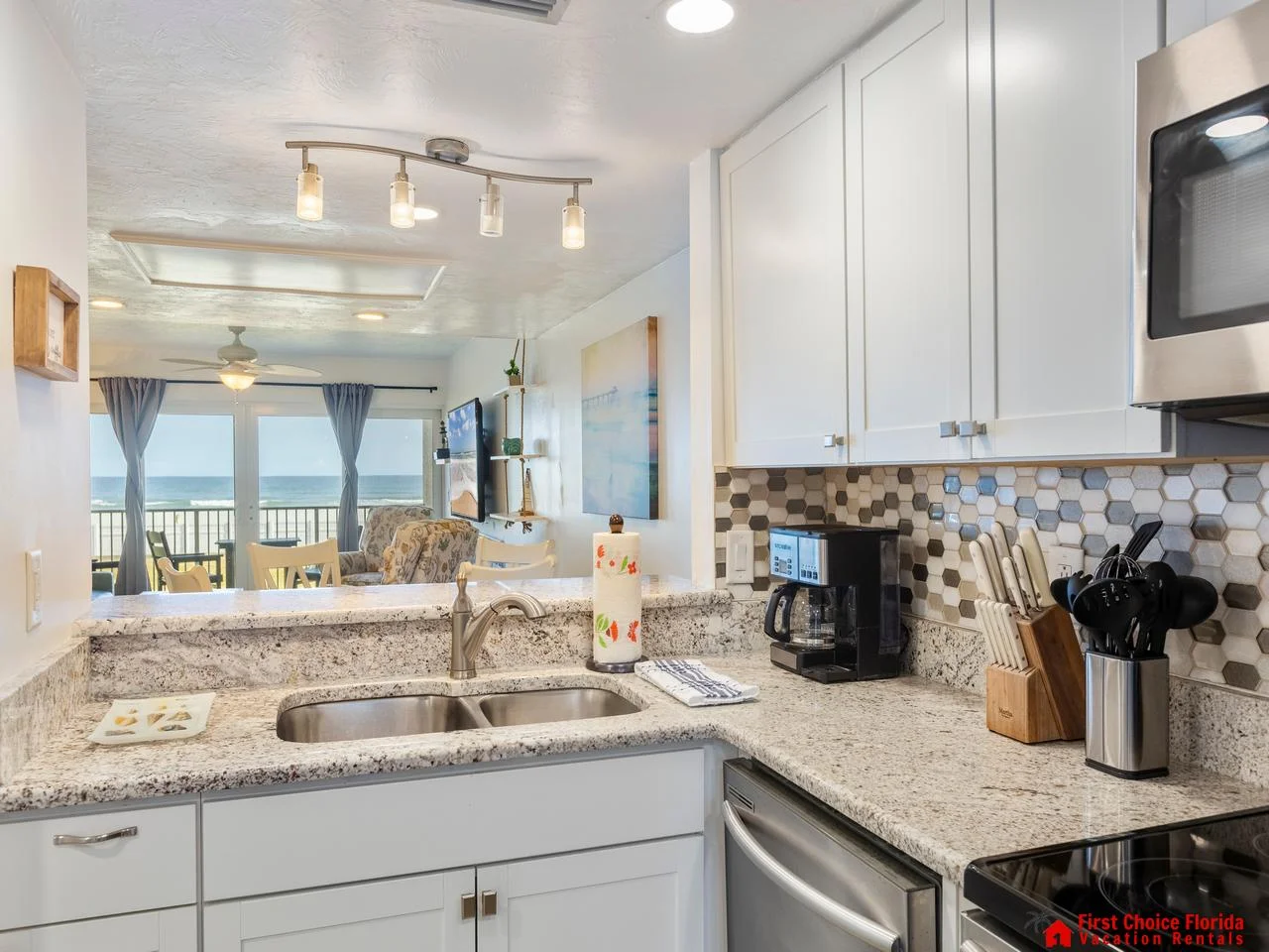 Bright, modern kitchen with ocean views and cozy seating