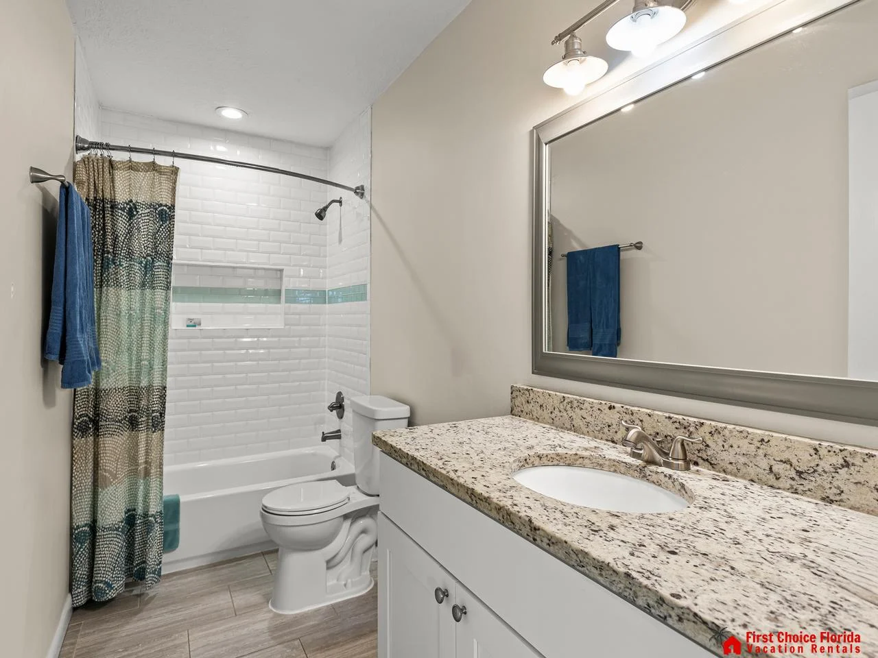 Bright bathroom with granite countertop and modern fixtures