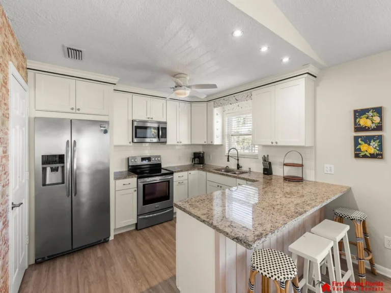 Modern kitchen with granite island and stainless steel appliances