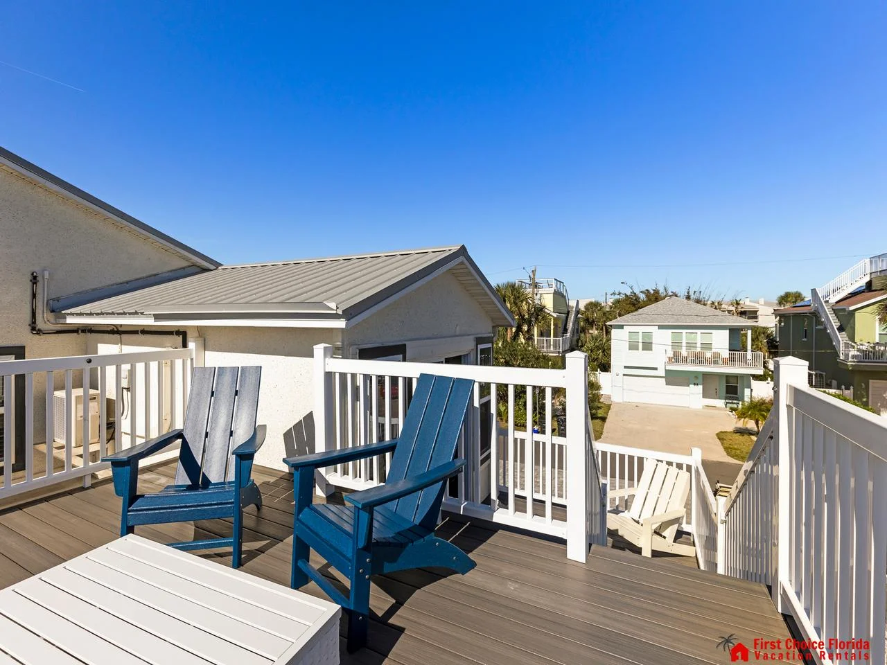 Sunny outdoor deck with cozy seating and neighborhood views