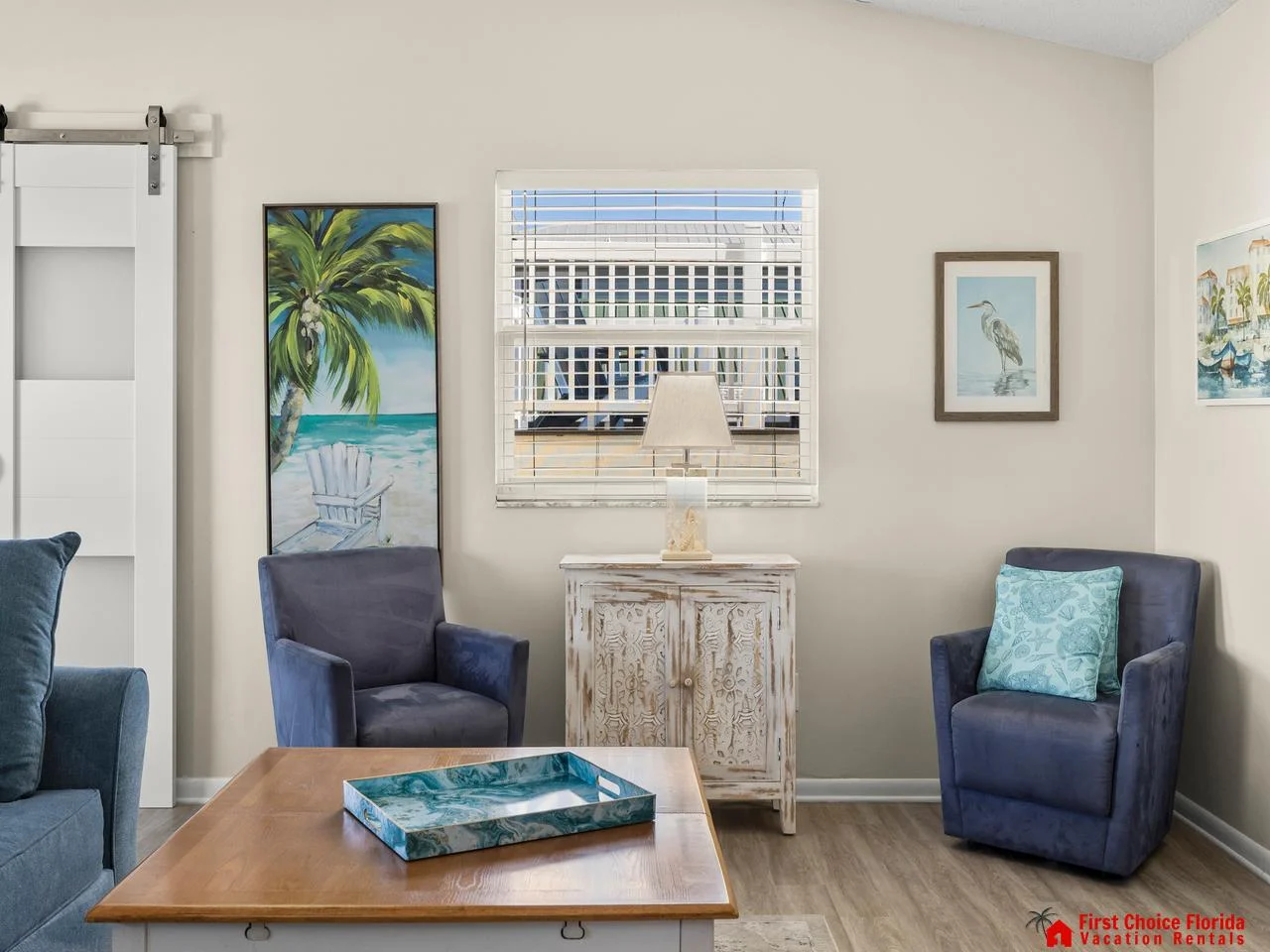 Cozy living room with vibrant coastal artwork and natural light