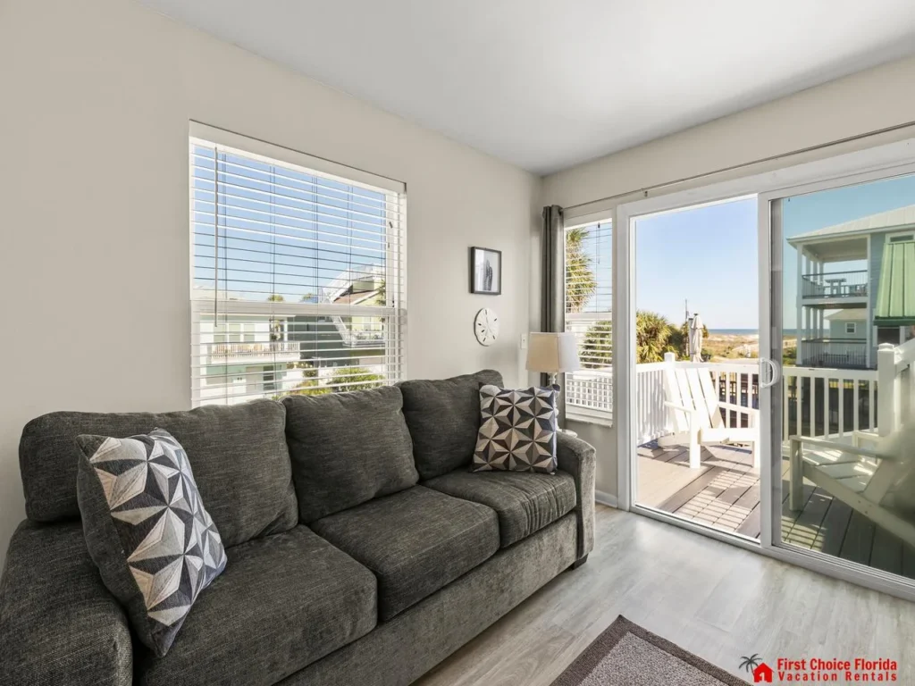 Cozy living room with bright natural light and balcony access