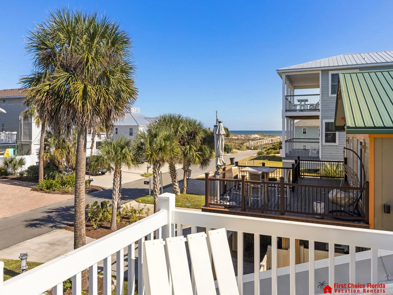 Sunny balcony retreat with palm tree views and ocean breeze