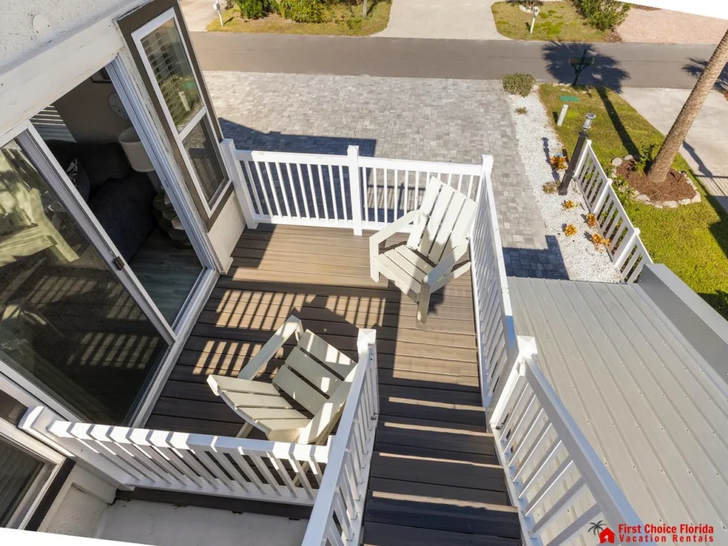 Sunlit outdoor deck with cozy seating and ocean views