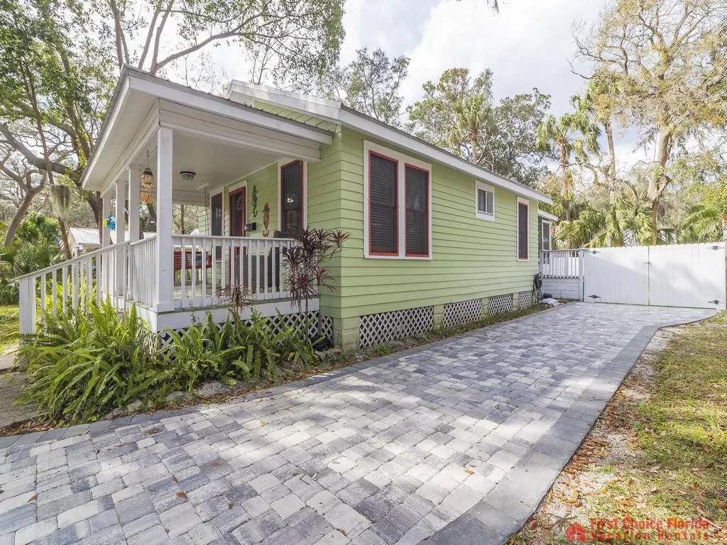 gray concrete deck and surrounded by lush greenery.
