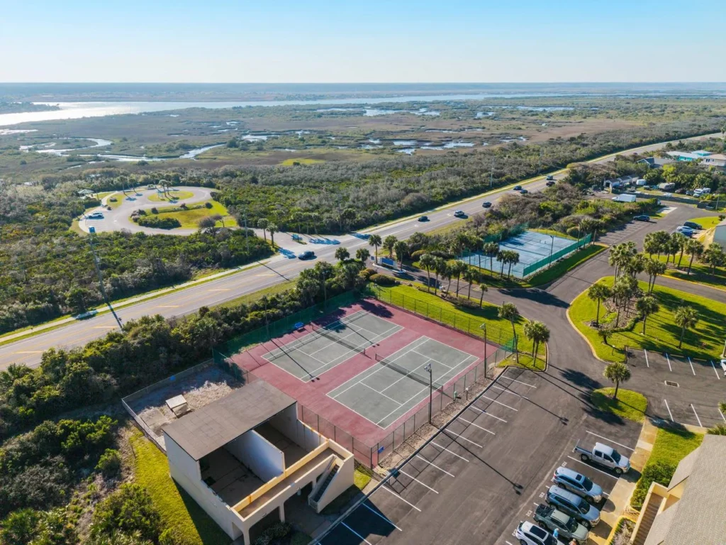Spacious outdoor tennis courts with scenic coastal views