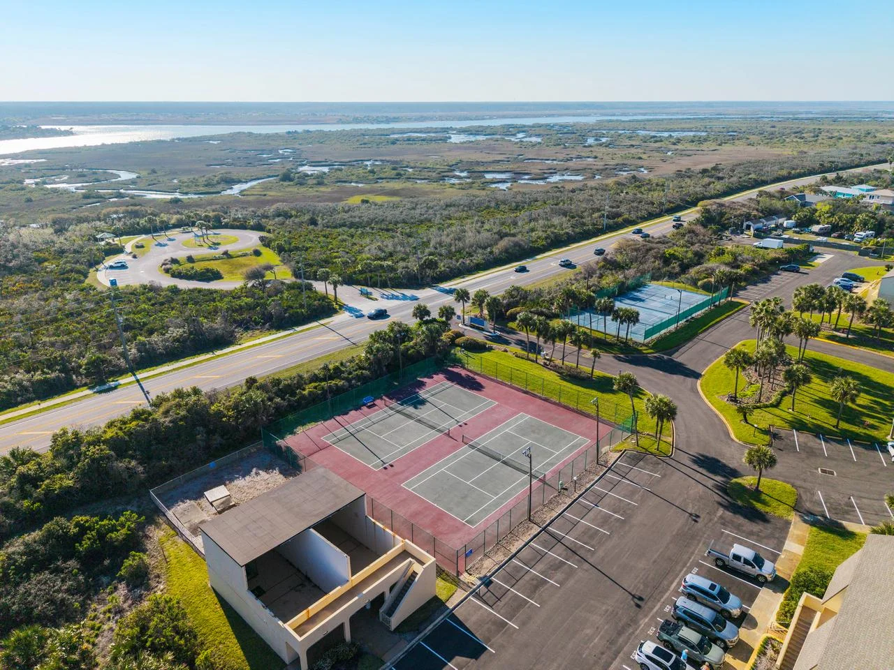 Spacious outdoor tennis courts with scenic coastal views
